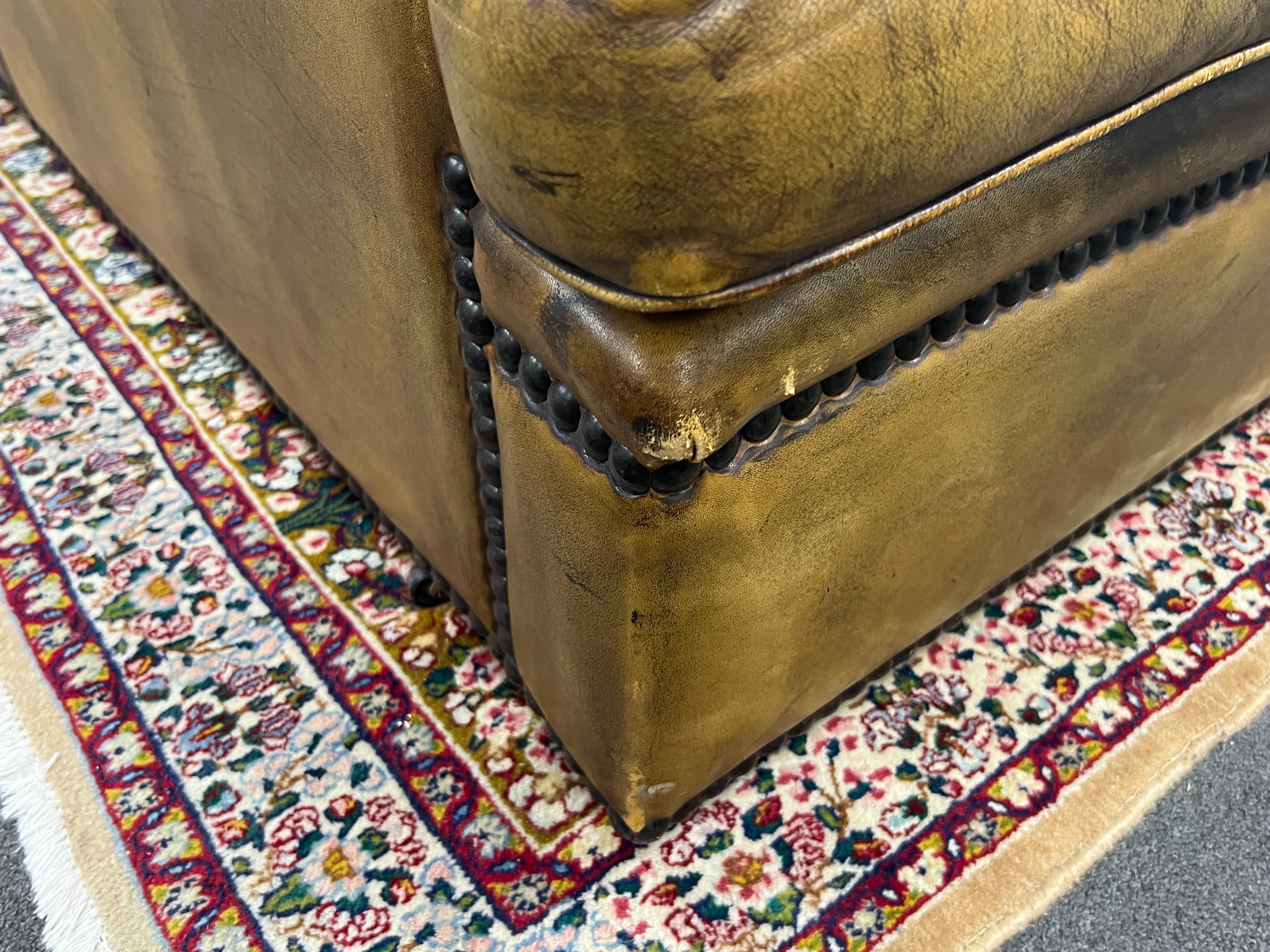 A pair of brown leather brass studded three seater settees, length 200cm, depth 90cm, height 84cm